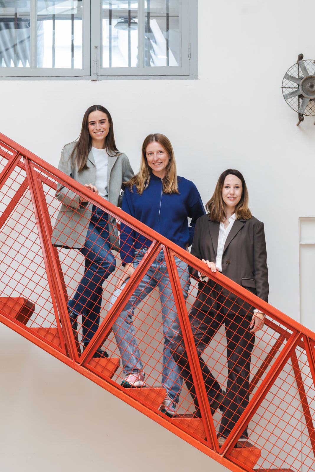 Las tres ganadoras de la Beca Wayco 2026 en una escalera roja